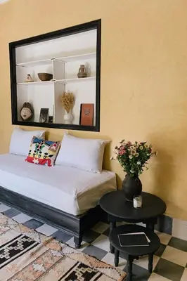 a bedroom with a bed with a mirror and a table at Riad Maison 24 in Marrakech