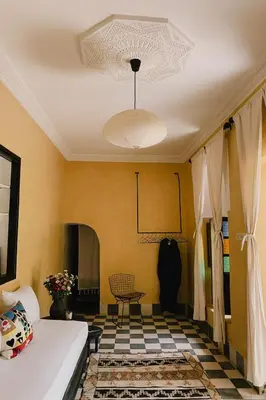 a living room with a bed and a ceiling at Riad Maison 24 in Marrakech