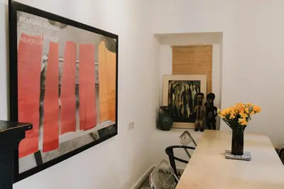 a dining room with a table and a picture on the wall at Riad Maison 24 in Marrakech