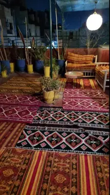 a room with colorful rugs on the floor with a couch at Marrakech Mirage Home in Marrakech