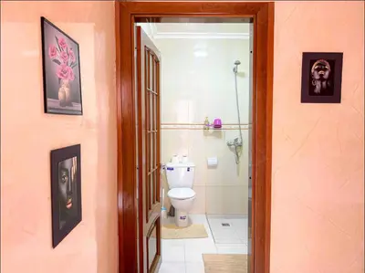 a bathroom with a toilet and a glass door at Marrakech Mirage Home in Marrakech