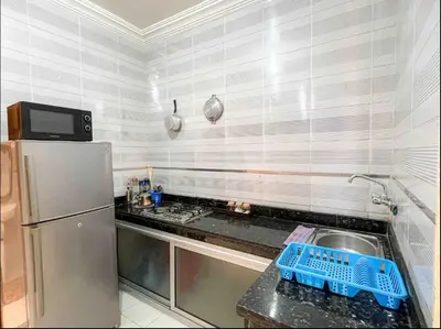 a small kitchen with a sink and a refrigerator at Marrakech Mirage Home in Marrakech