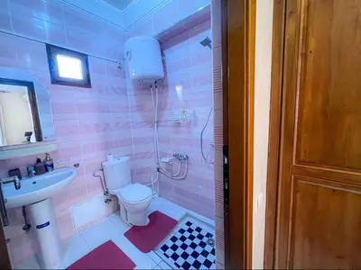a pink bathroom with a toilet and a sink at Marrakech Mirage Home in Marrakech