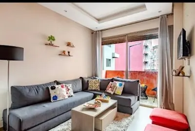 a living room with a couch and a table at Coquet studio pour vacance in Marrakech