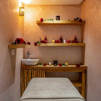 a bathroom with a bed and a sink and shelves at MAISON SOLANEOS in Marrakech