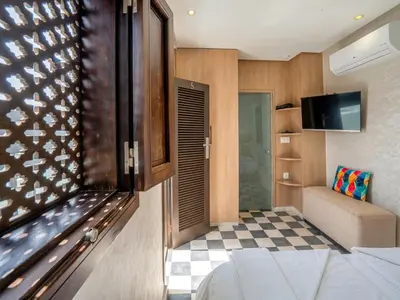 a room with a bed and a tv and a couch at MAISON SOLANEOS in Marrakech