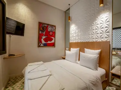 a bedroom with a large white bed in a room at MAISON SOLANEOS in Marrakech