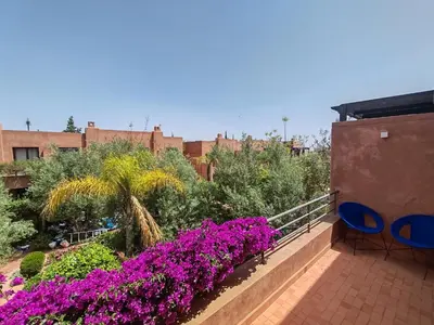 a balcony with purple flowers and plants at Pavillon Affaoui Golf & Waky in Marrakech