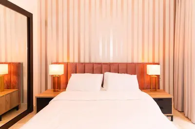 a bedroom with a large bed with two lamps at Pavillon Affaoui Golf & Waky in Marrakech