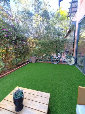 a yard with a green lawn with a table and a bike at Pavillon Affaoui Golf & Waky in Marrakech