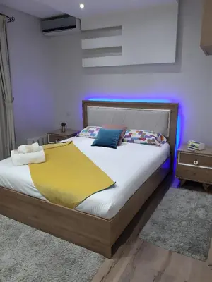 a bedroom with a bed with a yellow blanket on it at Appartement pour Familles en Résidence-Piscine et WiFi Fibre Optique in Marrakech