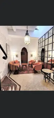 a large room with couches and tables in it at Riad privatisé jusqu a 5 personnes a 5 minutes place jemma El fna loué avec ménage et petit déjeuner compris in Marrakech