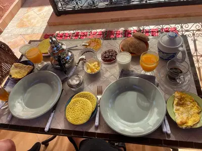 a table with plates of food on a table at Riad privatisé jusqu a 5 personnes a 5 minutes place jemma El fna loué avec ménage et petit déjeuner compris in Marrakech