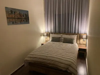 a bedroom with a bed with two pillows and a window at Appartment Zaina in Marrakech
