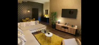 a living room with a couch and a table at Appartment Zaina in Marrakech