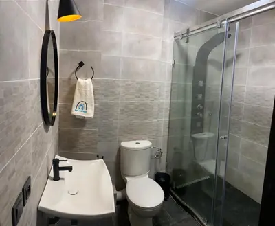 a bathroom with a shower and a toilet and a sink at Appartment Zaina in Marrakech