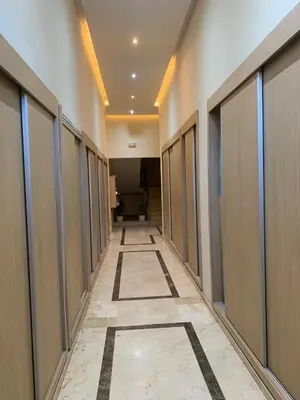 a hallway of an office with doors and a tile floor at Appartement avec piscine in Marrakech