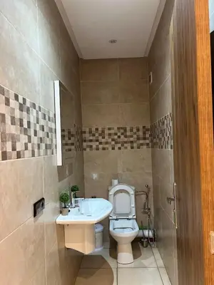 a bathroom with a toilet and a sink at Appartement avec piscine in Marrakech