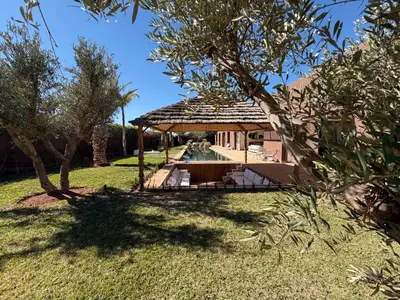 a gazebo with a pool in a yard at Villa Zen'O Palmeraie - Hot Pool in Marrakech