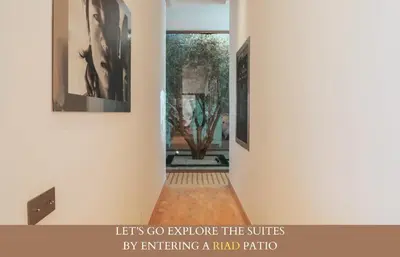 a hallway with two paintings on the walls and a painting on the wall at Villa Zen'O Palmeraie - Hot Pool in Marrakech