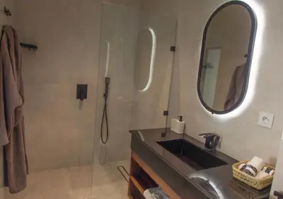 a bathroom with a sink and a shower with a mirror at Vista de La Palma in Marrakech