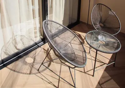 three chairs with a bird sitting on top of them at Vista de La Palma in Marrakech