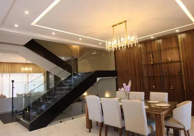 a dining room with a table and a staircase at Vista de La Palma in Marrakech