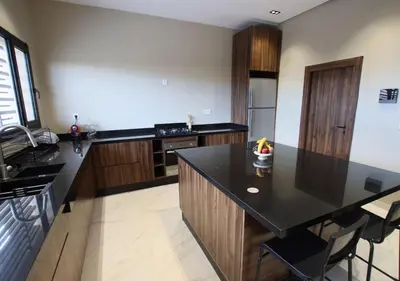 a kitchen with a black counter top and wooden cabinets at Vista de La Palma in Marrakech