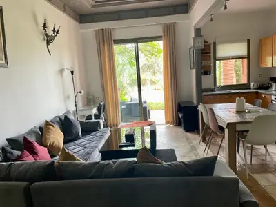 a living room with a couch and a table at Au Cœur de la Palmeraie de Marrakech in Marrakech