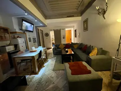 a living room with a couch and a table at Au Cœur de la Palmeraie de Marrakech in Marrakech