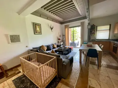 a living room with a couch and a table at Au Cœur de la Palmeraie de Marrakech in Marrakech