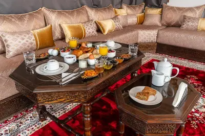 a living room with a tray of food on a coffee table at Yanis Guest House in Marrakech