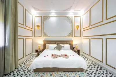 a bedroom with a bed with two bow ties on it at Yanis Guest House in Marrakech