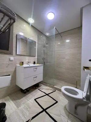 a bathroom with a toilet and a sink and a shower at Prestigia golf city porte agate in Marrakech