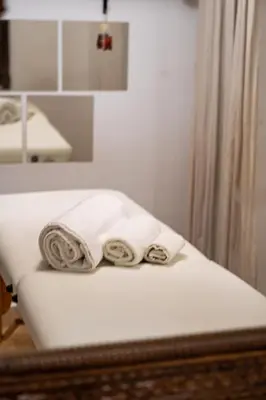 two towels sitting on a bed in a bathroom at Riad Nalan & Spa in Marrakech