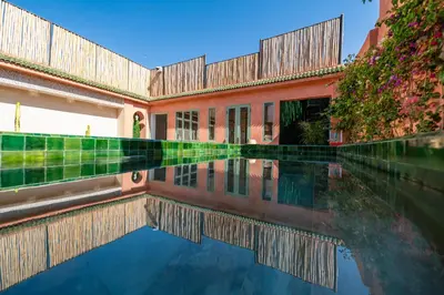 a pool of water in front of a building at Riad Nalan & Spa in Marrakech