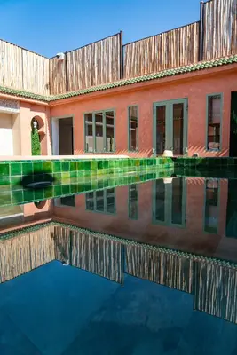 a pool of water in front of a building at Riad Nalan & Spa in Marrakech