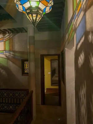 a room with a stained glass ceiling and a hallway at Riad Alena in Marrakech