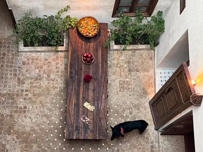 an overhead view of a wooden table with a dog on it at Riad Alena in Marrakech