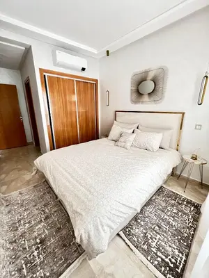 a bedroom with a large bed with a wooden headboard at Arras operah marrakech in Marrakech