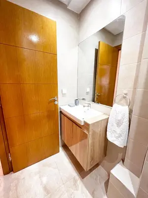a bathroom with a sink and a wooden door at Arras operah marrakech in Marrakech