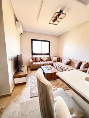 a living room with a couch and a tv at Arras operah marrakech in Marrakech