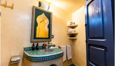 a bathroom with a sink and a mirror at Riad 4 Jardins & Spa in Marrakech