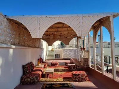 a porch with couches and a table on a building at Riad 4 Jardins & Spa in Marrakech