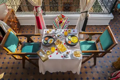 an overhead view of a table with plates of food at Riad Diamond Of Marrakech & Spa in Marrakech