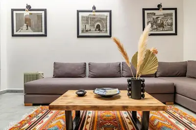 a living room with a couch and a coffee table at Maison Meurisse Marrakech in Marrakech