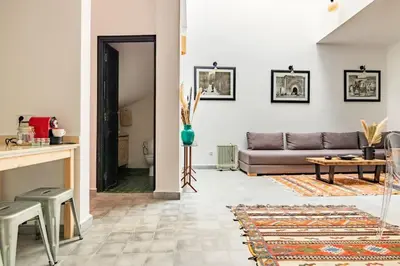 a living room with a couch and a table at Maison Meurisse Marrakech in Marrakech