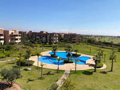 an overhead view of a pool with palm trees and buildings at Prestigia jade Marrakech ENTREE 191 APPARTEMENT 9 in Marrakech