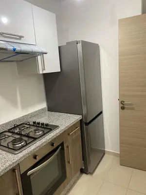 a kitchen with a stove and a refrigerator at Prestigia jade Marrakech ENTREE 191 APPARTEMENT 9 in Marrakech
