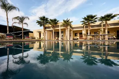 a resort with palm trees and a swimming pool at Dar Meha in Marrakech